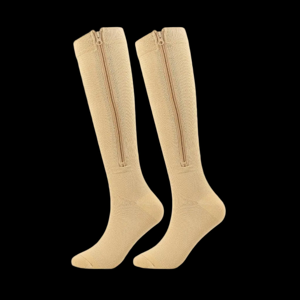 Pair of beige knee-high socks with zippers on a white background